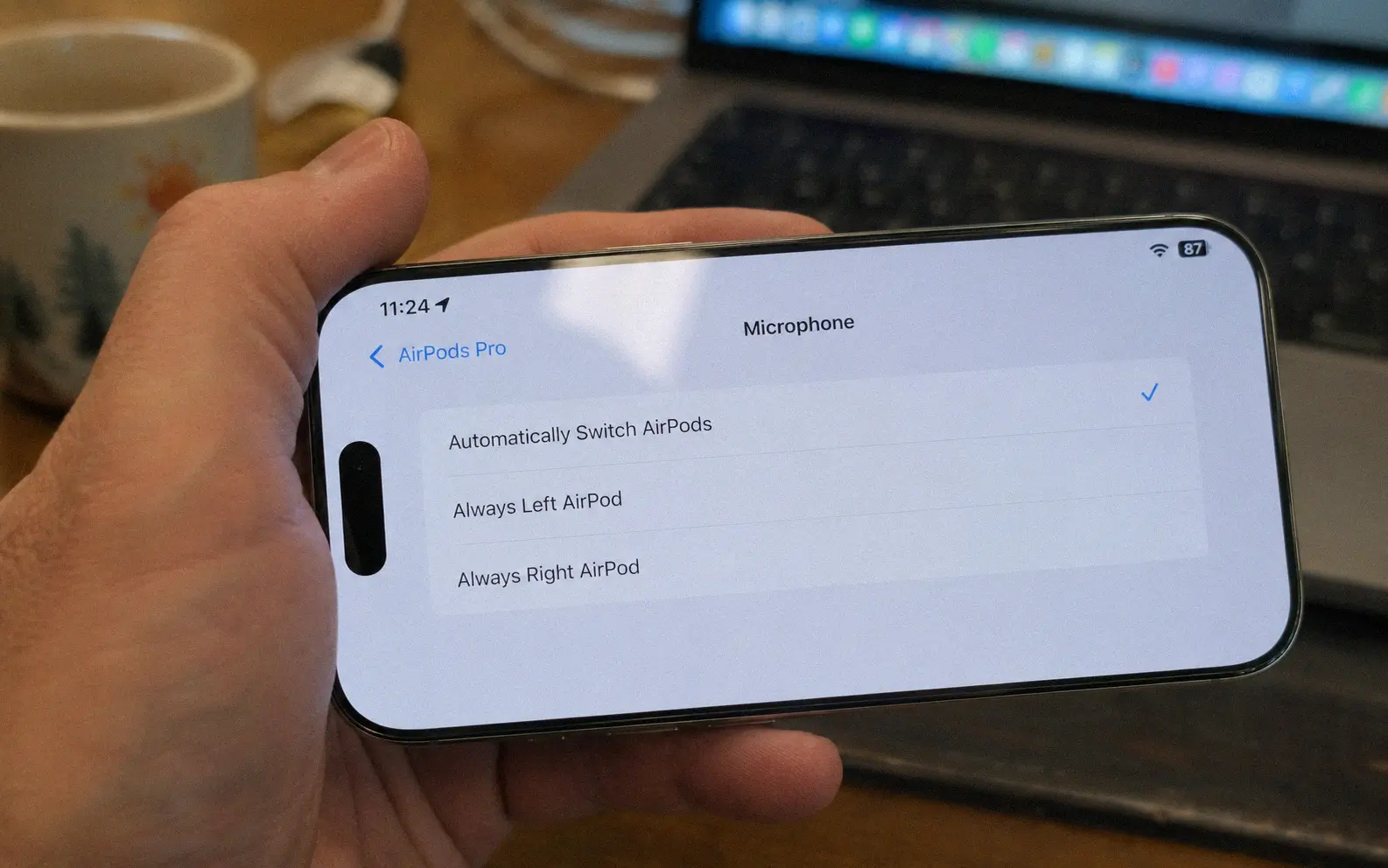 iPhone screen showing AirPods Bluetooth microphone settings with Automatically Switch AirPods selected